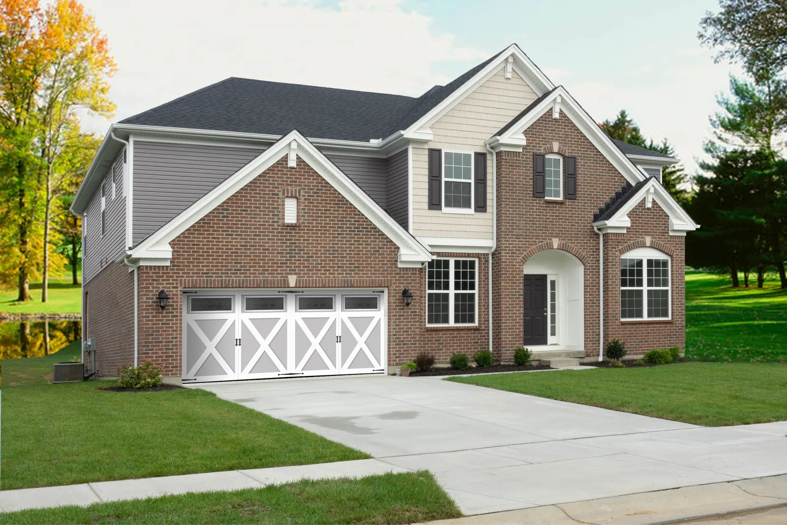 Aristocrat Presidential doors with Diamond Pewter window inserts on a brick home