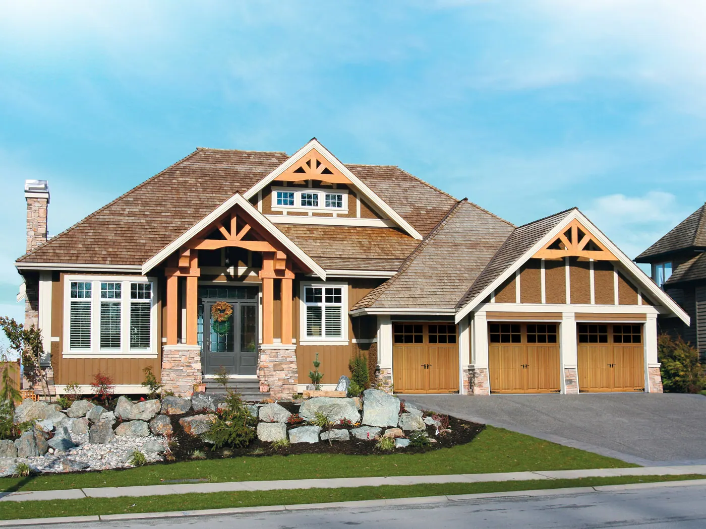 Safe-Way Aristocrat carriage doors on a stone-and-timber craftsman home