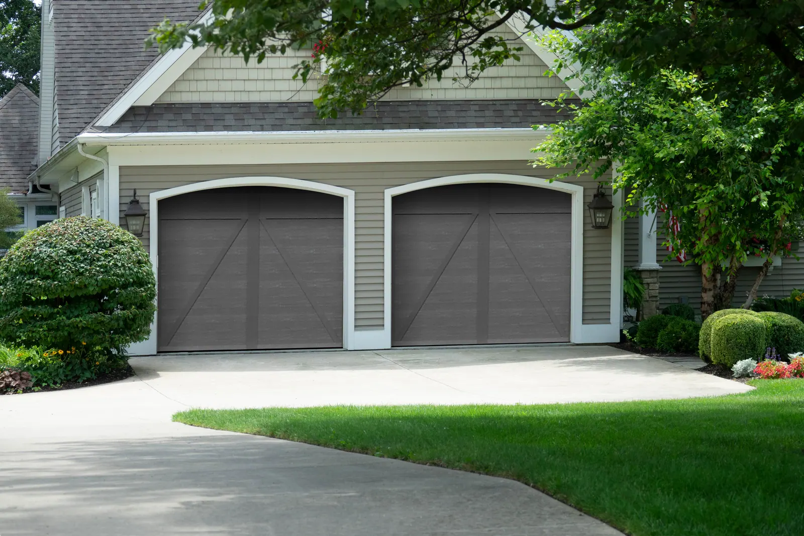 Two Aristocrat Presidential doors in a dark finish on an attached garage